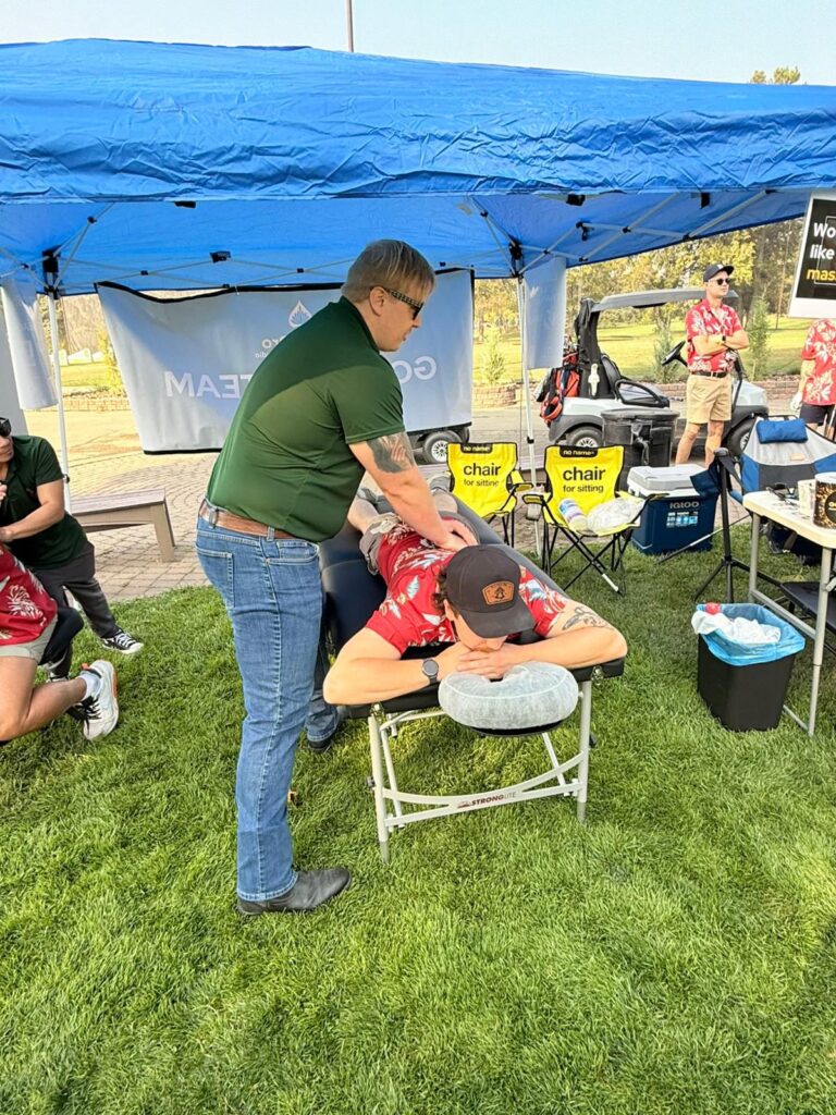 RMT Mason massaging golfer at event